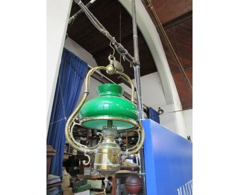 A brass hanging light, with a green glass shade, height 24ins