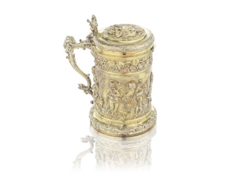 A good George III silver-gilt large lidded tankardWilliam Frisbee, London 1809 Tall cylindrical form, the body cast and appli