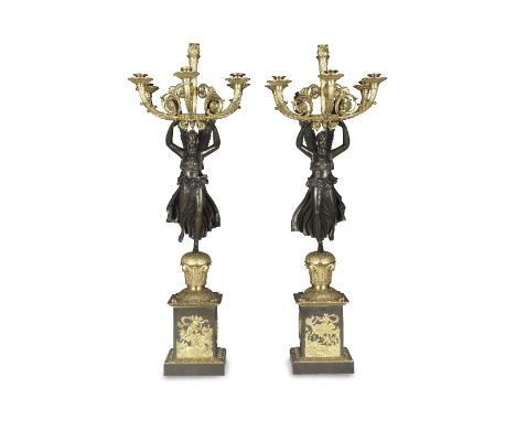 A pair of impressive French patinated and gilt bronze six light figural candelabraIn the Empire taste, the figures of Victory