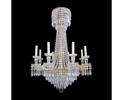 An early 19th century eight light gilt brass and cut glass tent and waterfall chandelierThe foliate scrolling short arms with