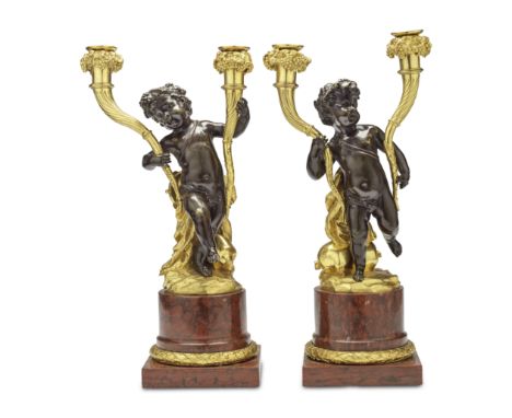 A pair of French patinated and gilt bronze and Rouge Griotte marble twin light figural candelabraPossibly early 19th century,