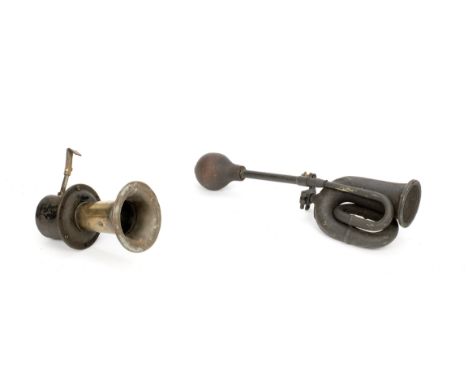 Two horns,comprising brass double-twist horn with bracket and fly-mesh, red rubber bulb (perished), 50cm long overall, and a 