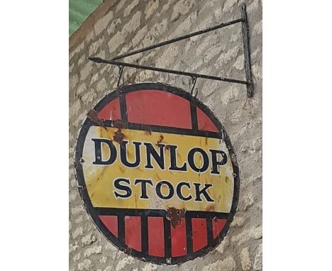 A Dunlop Stock circular enamel sign,double sided hanging type, in red, black and yellow, weathered with some chips, loss and 
