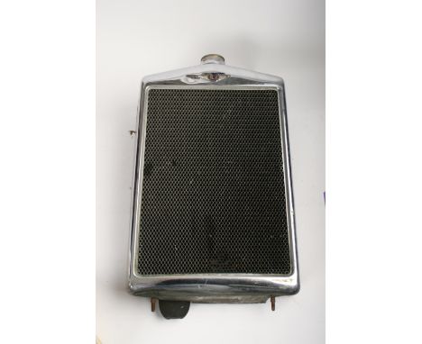 A Morris Cowley 'Flatnose' radiator,chrome-plated with enamel badge, surround dented and scratched, badge lacking most enamel