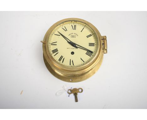 A German brass bulkhead clock with Swiss movement by ODH,brass case with hinged lid, cream painted dial with Roman numerals, 
