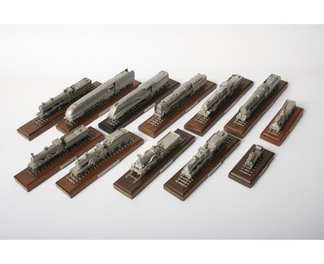 Twelve small scale pewter models of locomotives,each mounted on track section with tender on wooden plinth with title plaque,