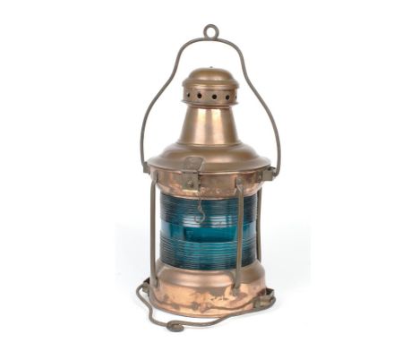 A large marine lamp,copper body, with green ribbed lens, with loop handle, 46cm high.  This lot is subject to the following l