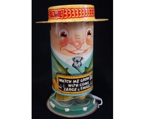 A VINTAGE 1930S TIN-PLATE MONEY BOX in the form of a man with a boater, 'Watch me grow tall' 15cm high