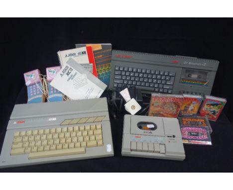 A SINCLAIR ZX SPECTRUM +2 with booklet and cassettes, an Atari '65XE' personal computer, with booklet, an Atari 'XC12' progra