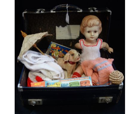 A VINTAGE BLUE CASE containing a Vintage plush dog, a doll, a Merit toddler's train and similar Vintage toys