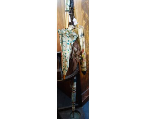 A VINTAGE UMBRELLA, the handle fashioned into the head of a dog, two other vintage umbrellas and an oriental paper parasol C.