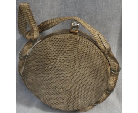 A LADY'S VINTAGE CIRCULAR HANDBAG in snakeskin with metal and moulded plastic clasp, the snakeskin carry handle woven through