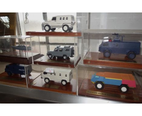 PROCUREMENT SERVICES INTERNATIONAL LTD; A SCALE MODEL OF A GLOVER WEBB TACTICA PATROL VEHICLE in a perspex case on a teak bas