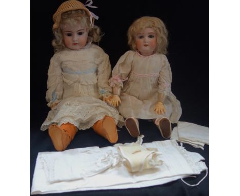 AN EARLY 20TH CENTURY BISQUE HEADED DOLL, stamped, ' 99 DEP GERMANY HANDWERCK 3' with a composite body, 53cm high (with some 