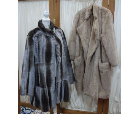 HARRODS OF KNIGHTSBRIDGE: A silver grey faux fur three quarter length lady's vintage coat and another similar in pale pink fu