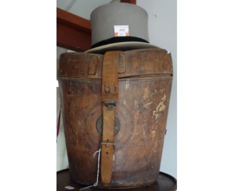 A GENTLEMAN'S VINTAGE LIGHT GREY TOP HAT by Scotts &amp; Co Piccadilly, hat size 22" and a leather top hat box with metal pla
