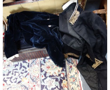 A 19TH CENTURY BLACK TRUNK, containing a black Gentleman's tailcoat, with brass wire decorated cuffs and collar and similar v