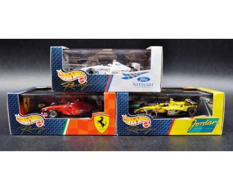 A collection of x3 Mattel made Hot Wheels 1/43 scale boxed diecast model F1 Formula One racing cars comprising; Ford Stewart 