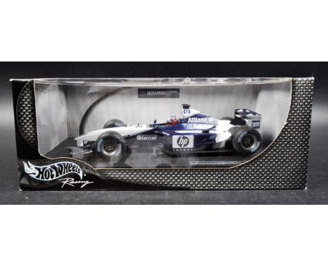 A Hot Wheels 1/18 scale boxed diecast model F1 Formula One racing car comprising; Williams F1 Team FW24 – Juan Pablo Montoya 