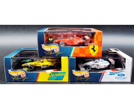 A collection of x3 Mattel made Hot Wheels 1/43 scale boxed diecast model F1 Formula One racing cars comprising; Ford Stewart 