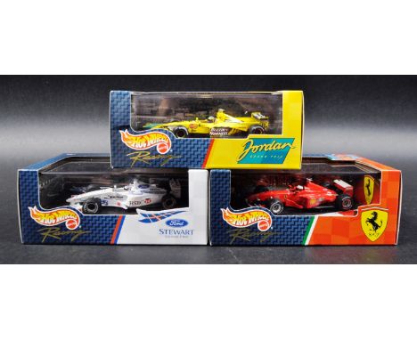 A collection of x3 Mattel made Hot Wheels 1/43 scale boxed diecast model F1 Formula One racing cars comprising; Ford Stewart 