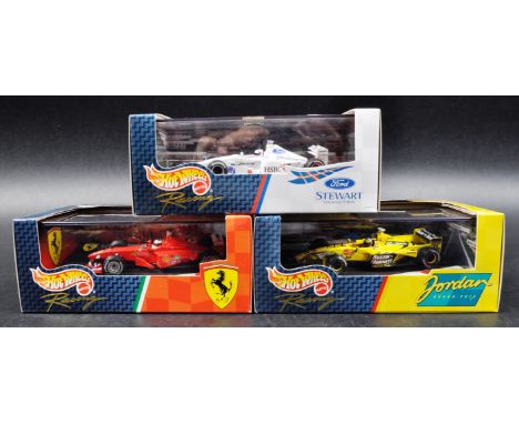 A collection of x3 Mattel made Hot Wheels 1/43 scale boxed diecast model F1 Formula One racing cars comprising; Ford Stewart 