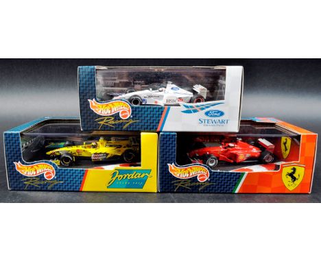 A collection of x3 Mattel made Hot Wheels 1/43 scale boxed diecast model F1 Formula One racing cars comprising; Ford Stewart 