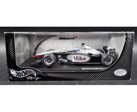A Hot Wheels 1/18 scale boxed diecast model F1 Formula One racing car comprising; McLaren MP4-16 – Mika Hakkinen (50198).&nbs
