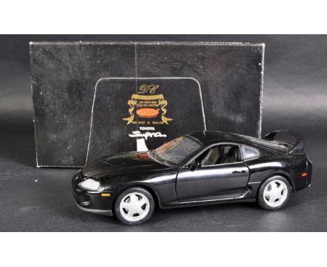 A Toyota Supra black diecast 1/18 scale model (08061K) car.&nbsp; Made by Kyosho.&nbsp; Example is boxed and in VG condition.