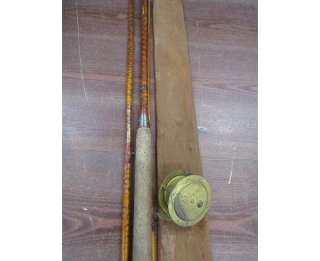 A vintage cane rod with vintage brass reel