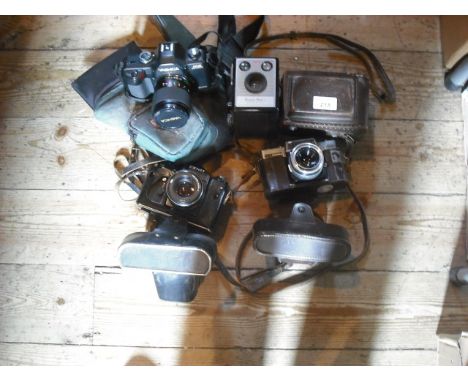 A leather cased Mamiya Flex camera and various other cameras.