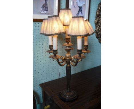 A six branch table lamp of neo classical design, wired for electricity, with shade, 64cm high overall.