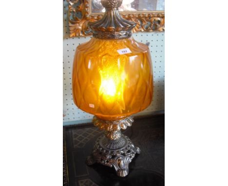 A gilt metal table lamp with amber glass shade, 60cm high.