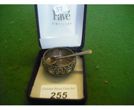 A Russian silver gilt and enamel salt and an associated silver spoon.