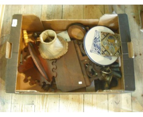 A 19th century Staffordshire blue and white transfer print teapot stand, a polychrome Delftware tile, a carved walnut wall br