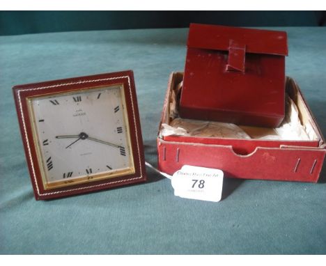 A Luxor travelling alarm clock by Garrard, in a leather case and outer box.