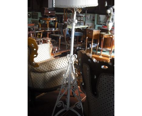 A later painted wrought iron standard lamp of tripod form, with shade.