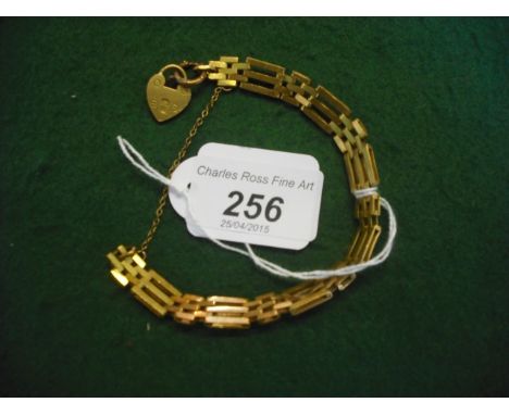 A yellow metal gate bracelet, the padlock clasp marked 22ct, otherwise unmarked.