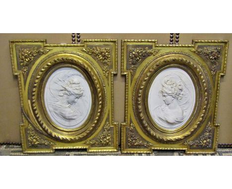 A decorative pair of composition Parian type portrait roundels of oval form set within moulded gilt frames, each 72 x 60 cm 