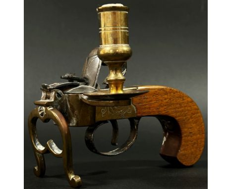 An Italian novelty reproduction tinder pistol table lighter with flintlock action brass framework and walnut grip, 13cm long.