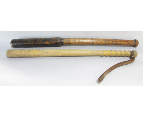 A long turned stained hardwood club/truncheon, 68 cm long together with a further large turned truncheon, 62 cm long (2) 