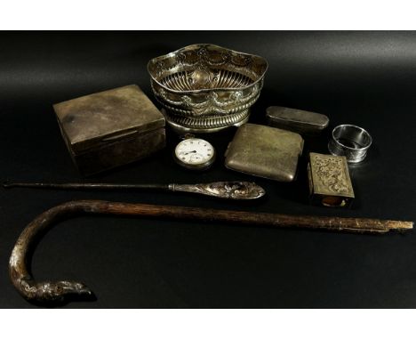 A mixed selection of silver ware including a cigarette box a cigarette case, a napkin ring, a matchbox cover, three small fra