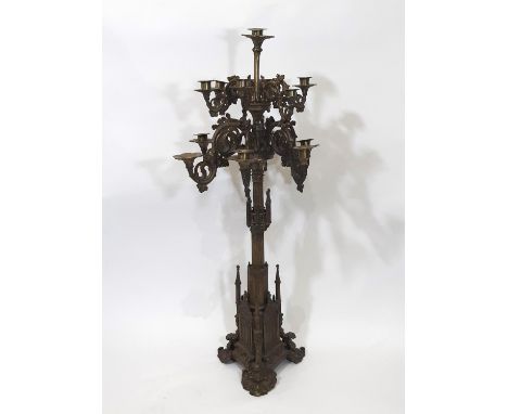 A tall and impressive puginesque 19th century continental gothic thirteen light floor-standing candelabra, with scrolling arm