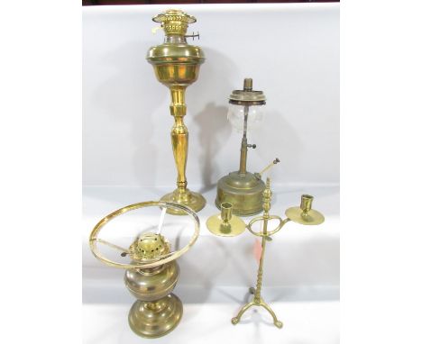A19th century brass adjustable candlestick raised on tripod paw supports, 38cm high, together with a simple brass oil lamp, a