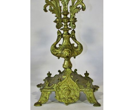 A pair of 19th century continental gilt-brass five light candelabras with scrolling acanthus branches over a platform base ra