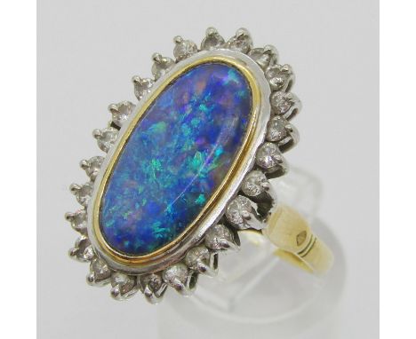 Good quality 18ct oval opal and diamond cluster ring, opal 18 x 10mm approx, size R, 9.2g (see photograph of Holman Jewellers