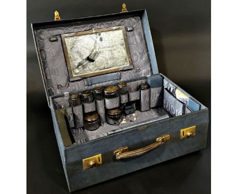 A good Edwardian cased travelling vanity case, with brass lock plates, in stitched blue leather with a divisional interior fi