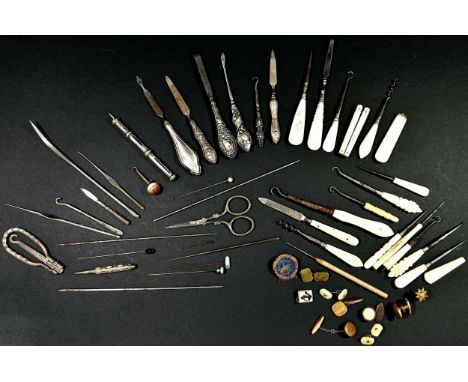 A collection of needlework tools to include several examples with silver handles etc 