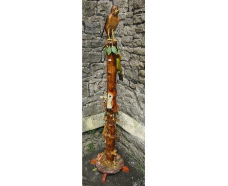 An unusual folk art post / totem decorated with applied carved and painted flora and fauna to include an owl, woodpecker, buz
