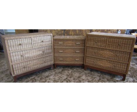 An associated pair of 20th century Indonesian wicker-clad chests of two short and two long drawers, raised on hardwood bracke